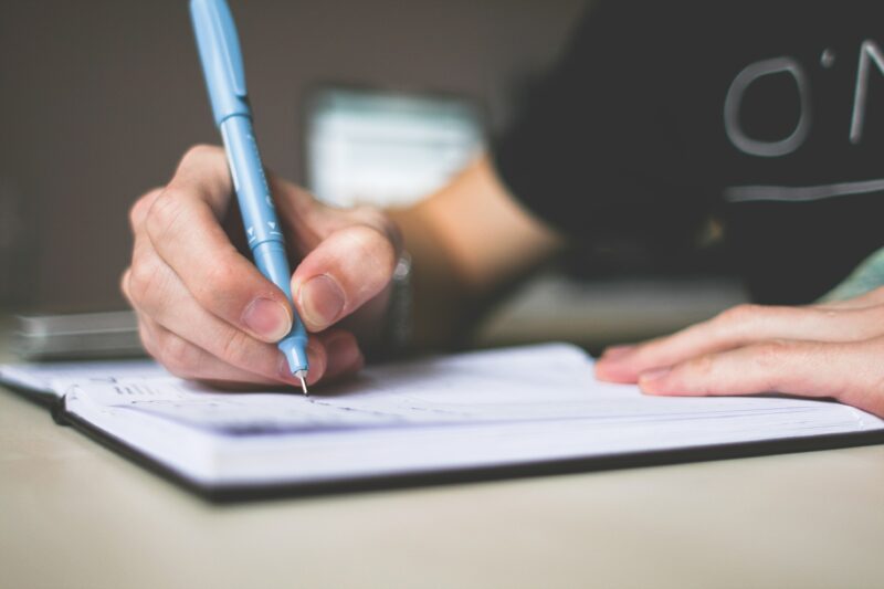 person writing in a journal